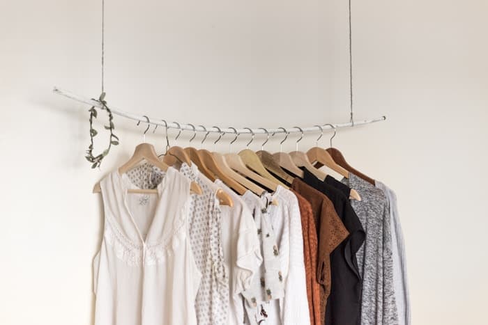 Neutral-toned clothing hanging on a rack